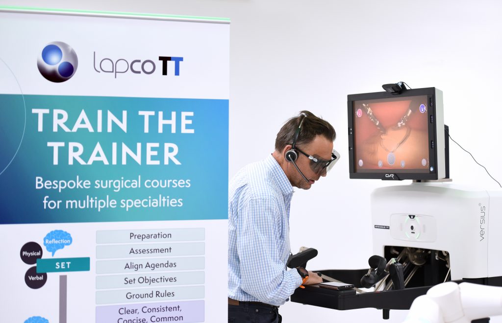 Surgeon demonstrating operating using a robot 